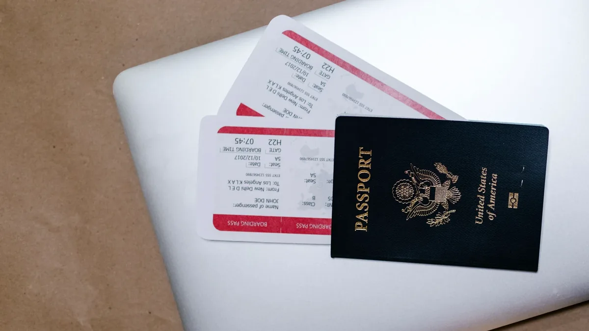 Passport and boarding pass representing student visa preparation